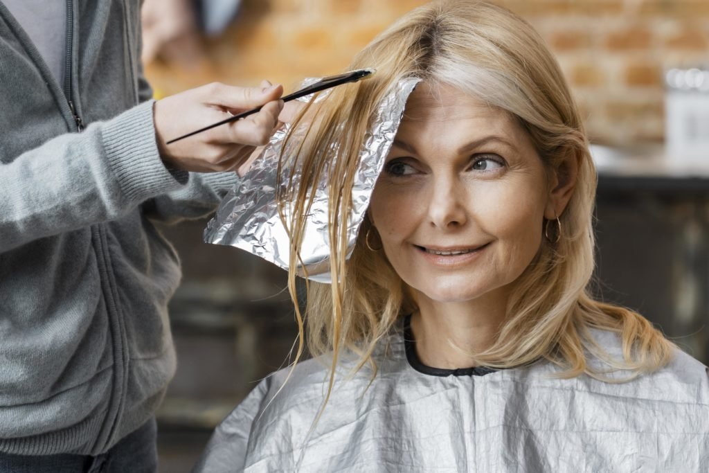 woman having hair dyed blonde